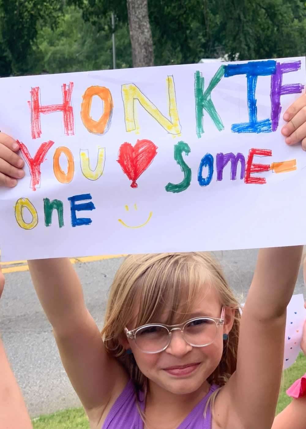 little girl holding sign
